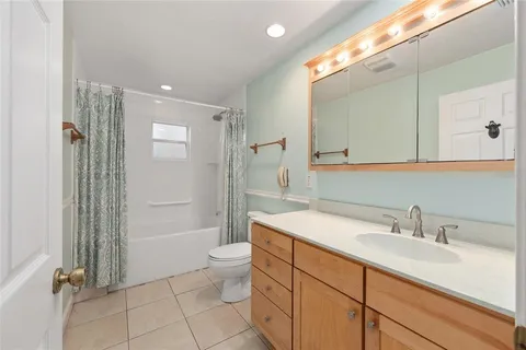 a bathroom with a sink toilet vanity and shower