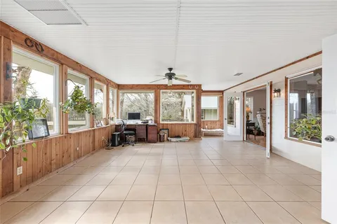 a living room with furniture and a painting on the wall