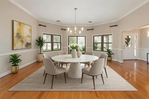 a living room with furniture a fireplace and a chandelier