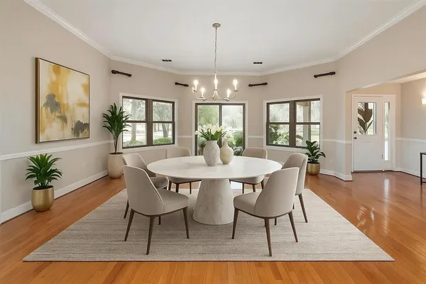 a living room with furniture a fireplace and a chandelier