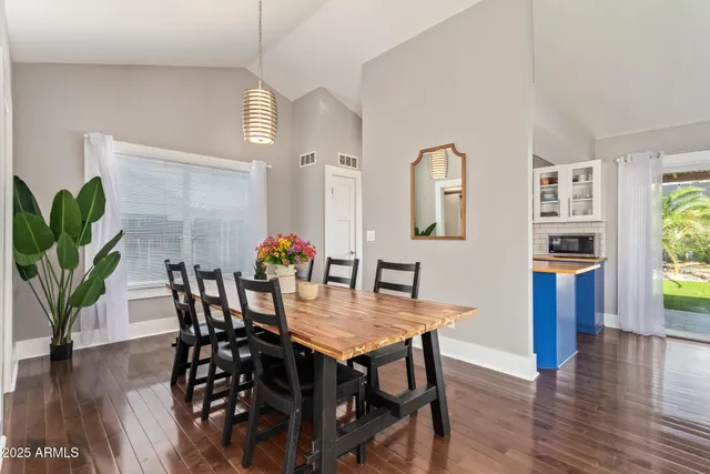 a view of a dining room with furniture and wooden floor