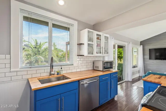 a kitchen with granite countertop a sink and a stove