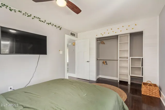 a bedroom with a bed and a flat screen tv