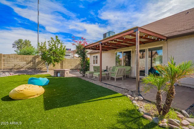 a backyard of a house with table and chairs