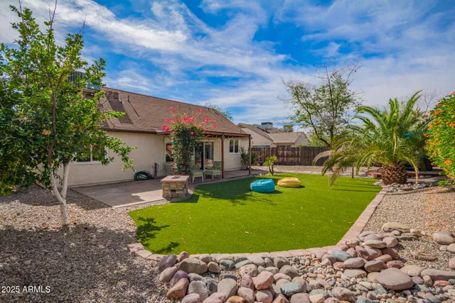 a view of a swimming pool with lounge chairs in patio