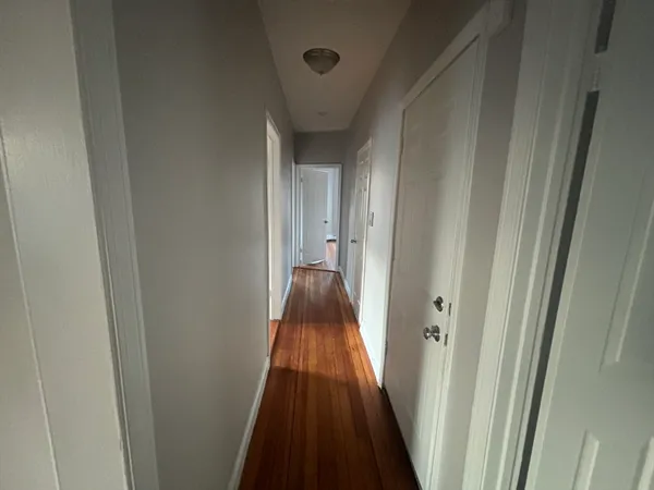 a view of a hallway with a wooden floor