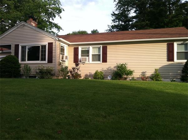 a front view of house with yard garden and outdoor seating