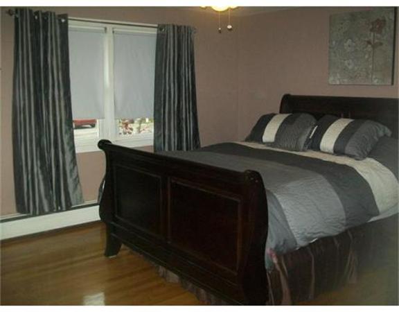 5 Fair Oak Road Springfield, MA 01128 - Photo 9 of 15 a bed sitting in a bedroom next to a window