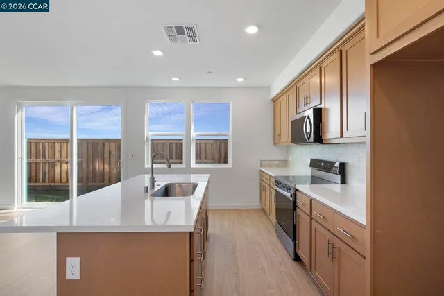 a kitchen with stainless steel appliances granite countertop a stove and a sink