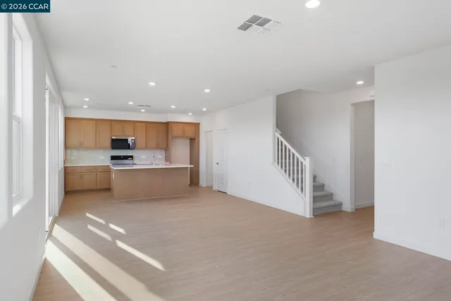 a view of a kitchen with a sink and cabinets
