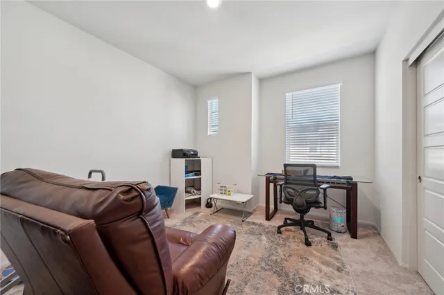 a living room with furniture a rug and a window