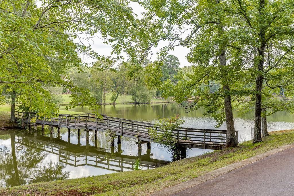5775 Kennedy Road Suwanee, GA 30024 - Photo 4 of 23 a view of a lake with a house in the background