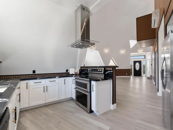 a white kitchen with a sink and a stove