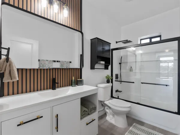 a bathroom with a sink toilet and mirror