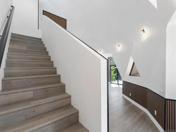 a view of an empty room and wooden floor