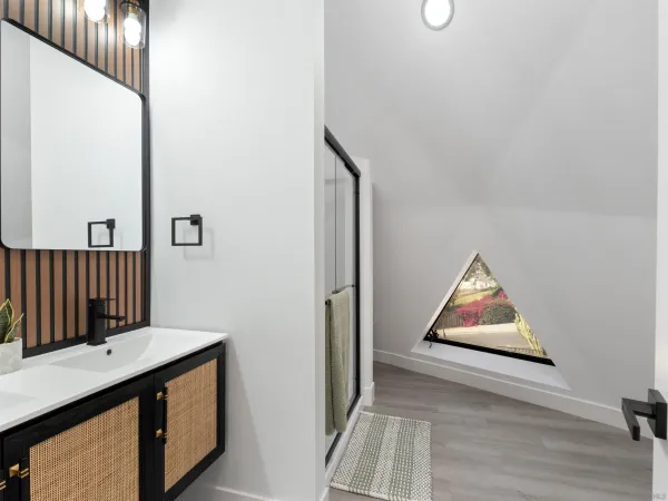 a bathroom with a double vanity sink a mirror and a shower