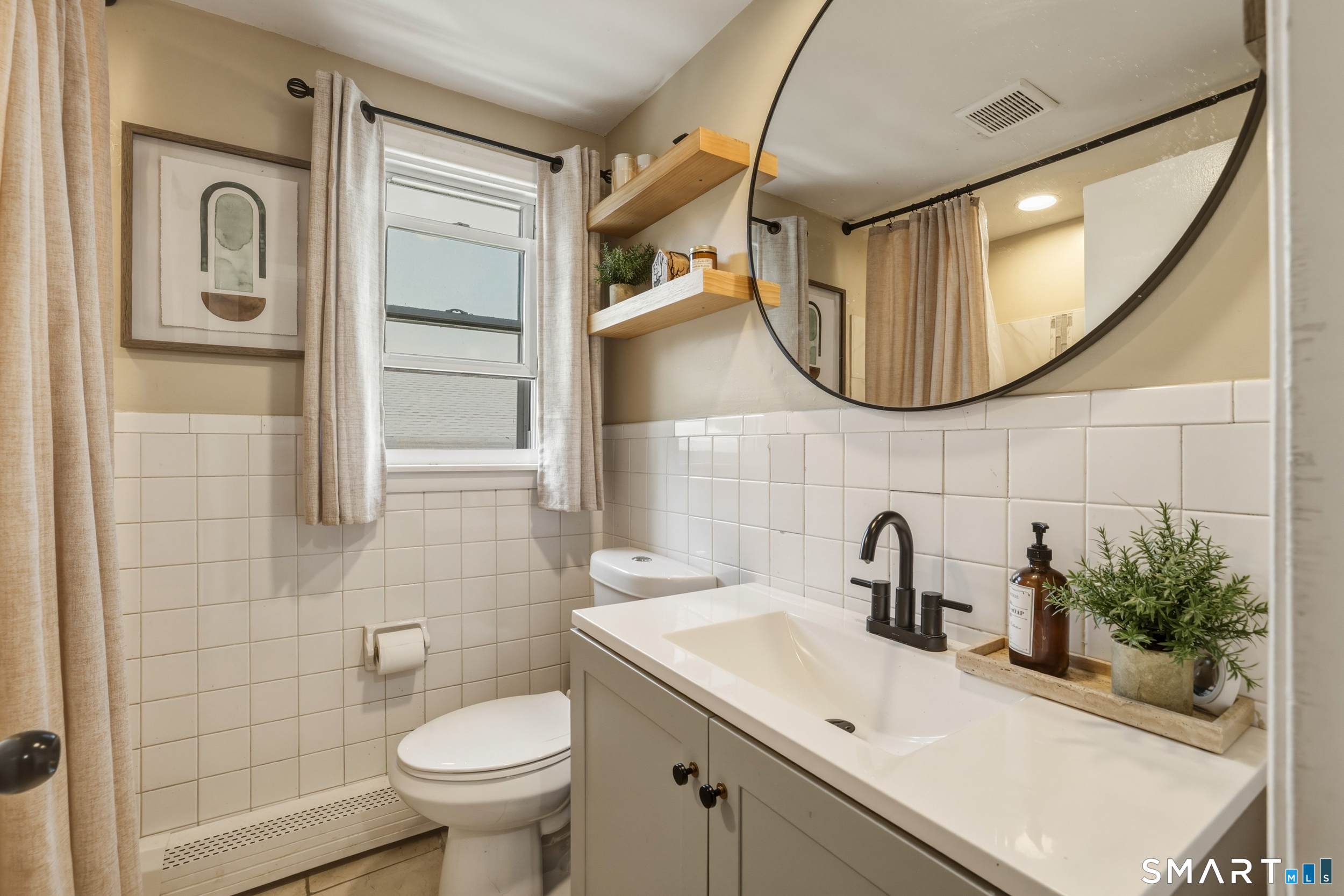 30 Lyndale Street Manchester, CT 06040 - Photo 25 of 37 a bathroom with a sink a mirror a toilet and a mirror