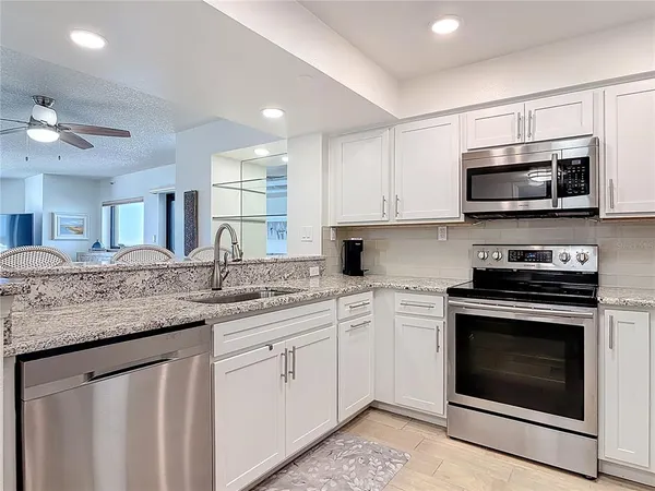 a kitchen with center island white cabinets and a sink