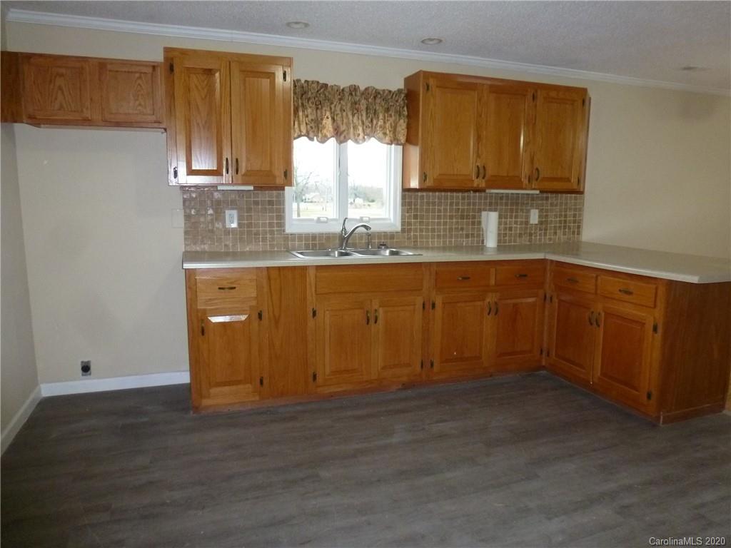 3643 Flat Creek Road Lancaster, SC 29720 - Photo 7 of 14 a kitchen with wooden cabinets and sink