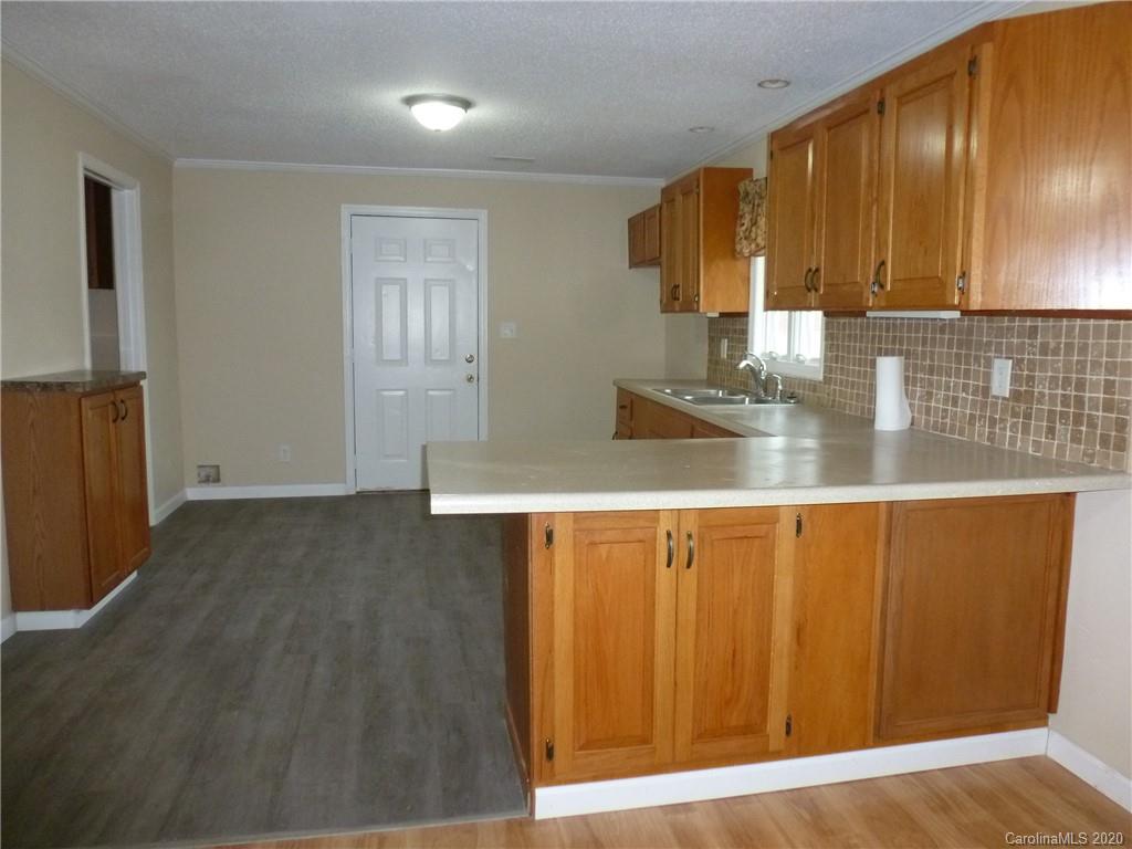 3643 Flat Creek Road Lancaster, SC 29720 - Photo 8 of 14 a kitchen with a sink cabinets and wooden floor