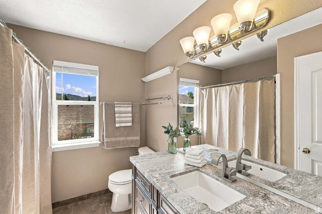 926 Ibis Way Draper, UT 84020 - Photo 17 of 41 Full bathroom with granite countertop, high end vanity, bathtub and shower.