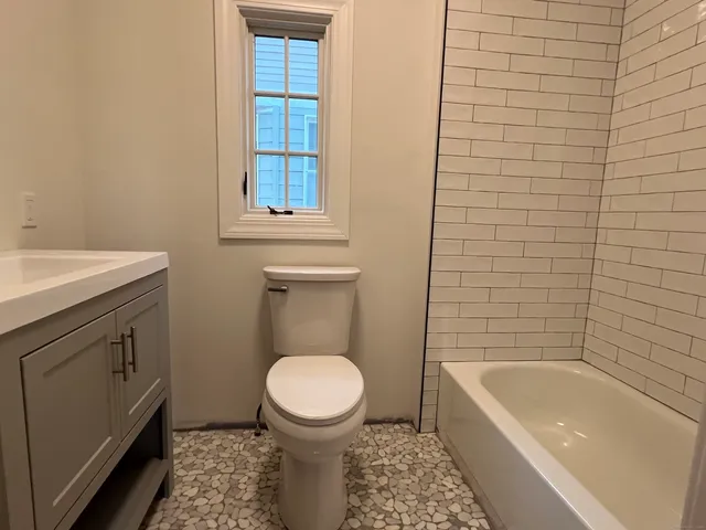 a bathroom with a sink a toilet and bathtub