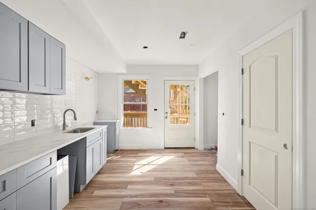 a view of a kitchen with a sink and windows