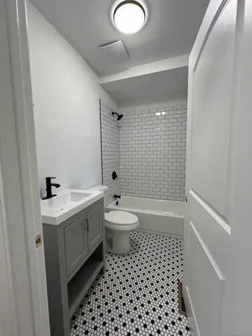 a bathroom with a double vanity sink toilet and shower
