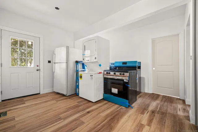 a kitchen with a refrigerator and a stove top oven