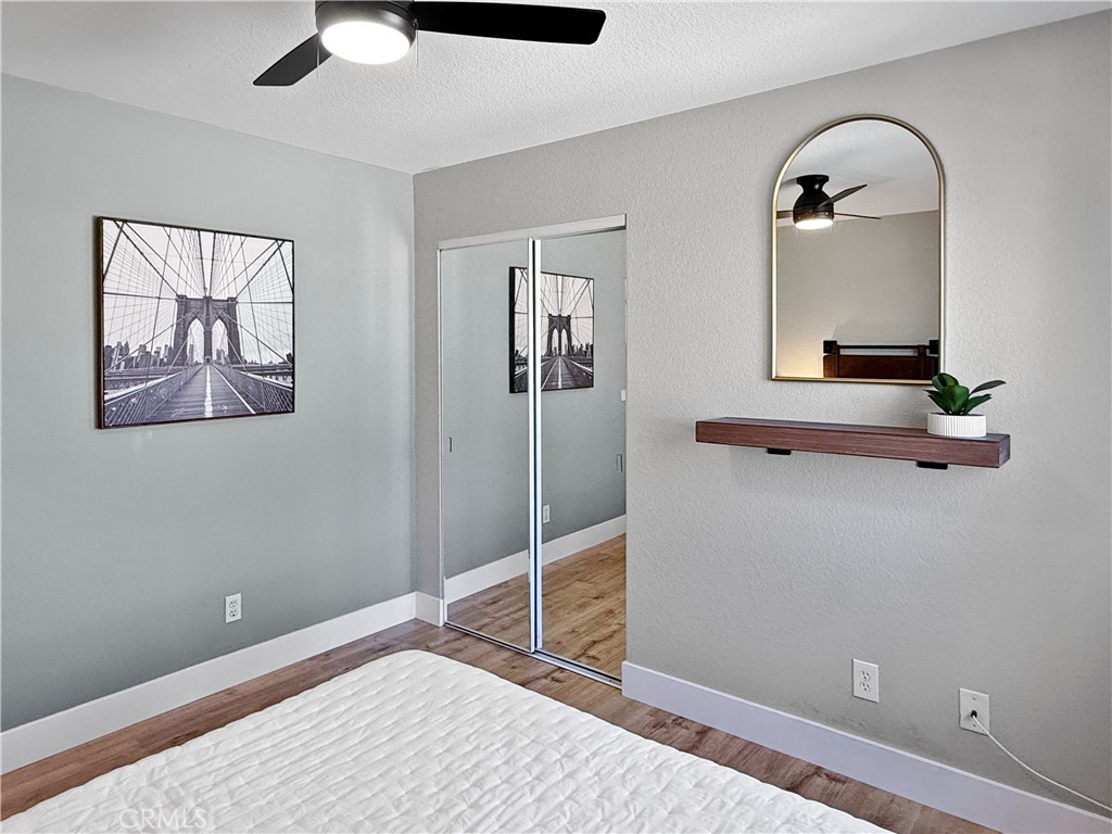 16955 Lake Knoll Parkway Riverside, CA 92503 - Photo 33 of 42 a bedroom with bed and wooden floor