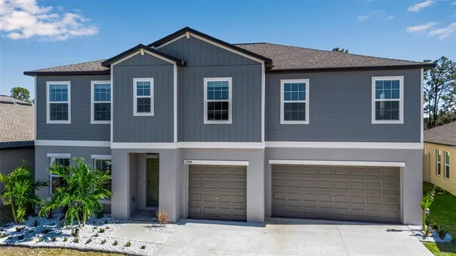 an aerial view of a house with a lake view