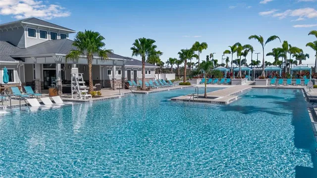 a dining room with furniture a chandelier and wooden floor