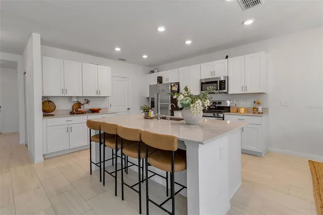 a living room with furniture ceiling fan and a window