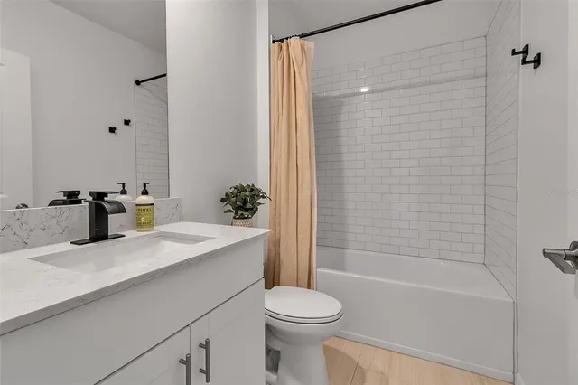 a bathroom with double vanity sink a mirror and shower