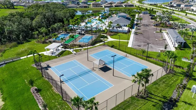 an aerial view of residential house with outdoor space and trees