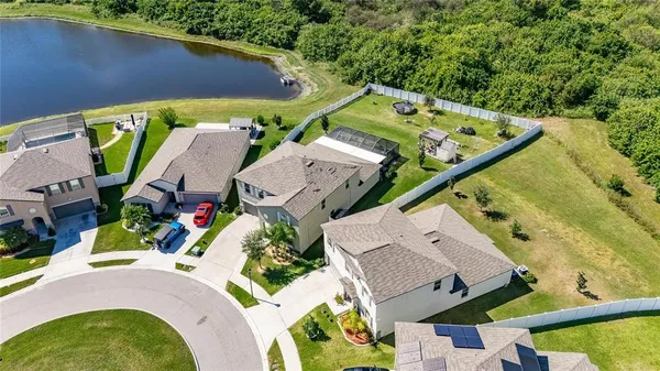 an aerial view of multiple houses with a yard