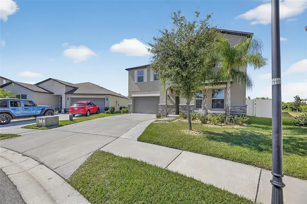 a front view of a house with a yard and garage