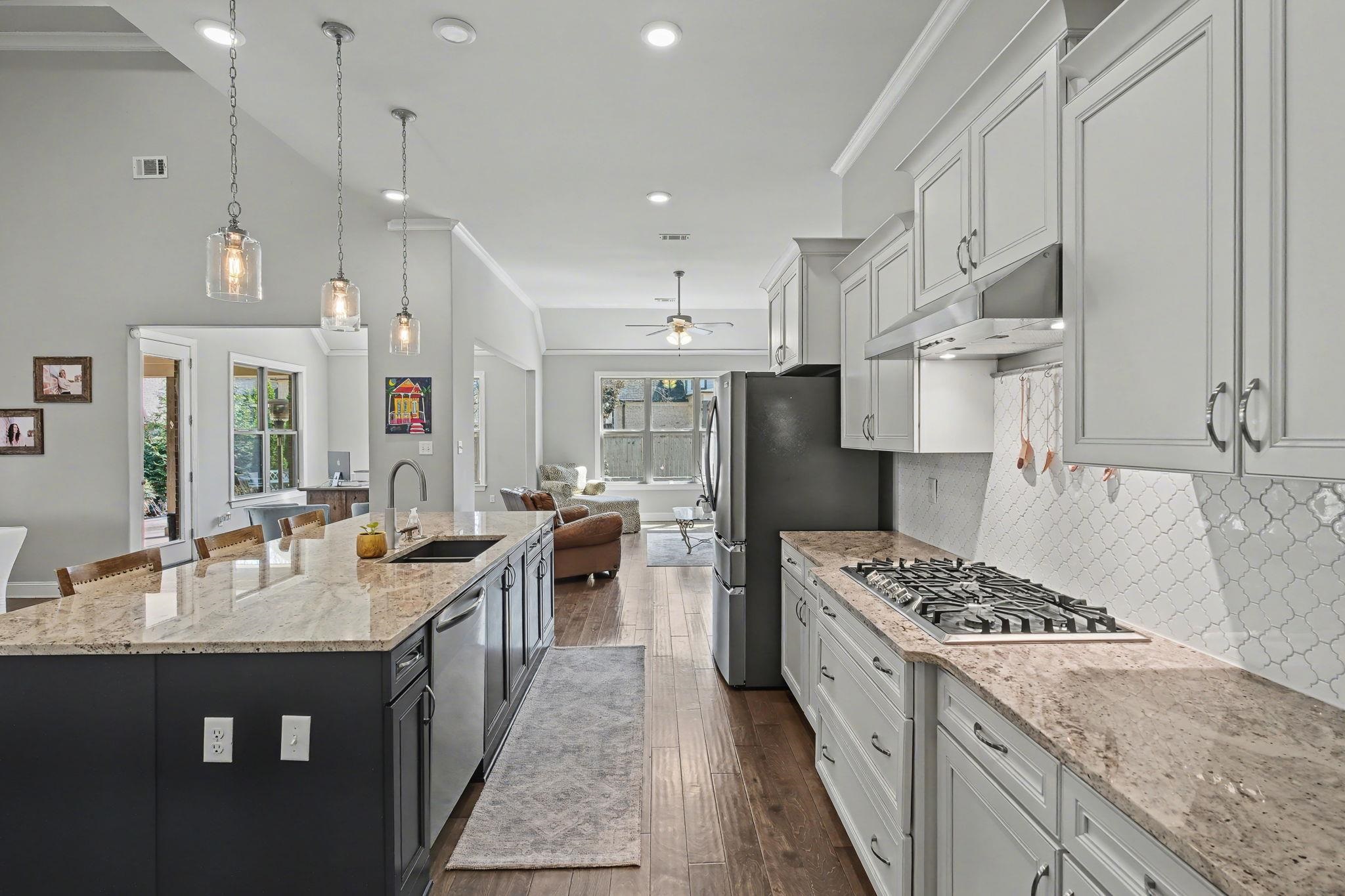 477 Fallen Timbers Cove Collierville, TN 38017 - Photo 13 of 40 a kitchen with kitchen island a counter top space a sink stainless steel appliances and cabinets