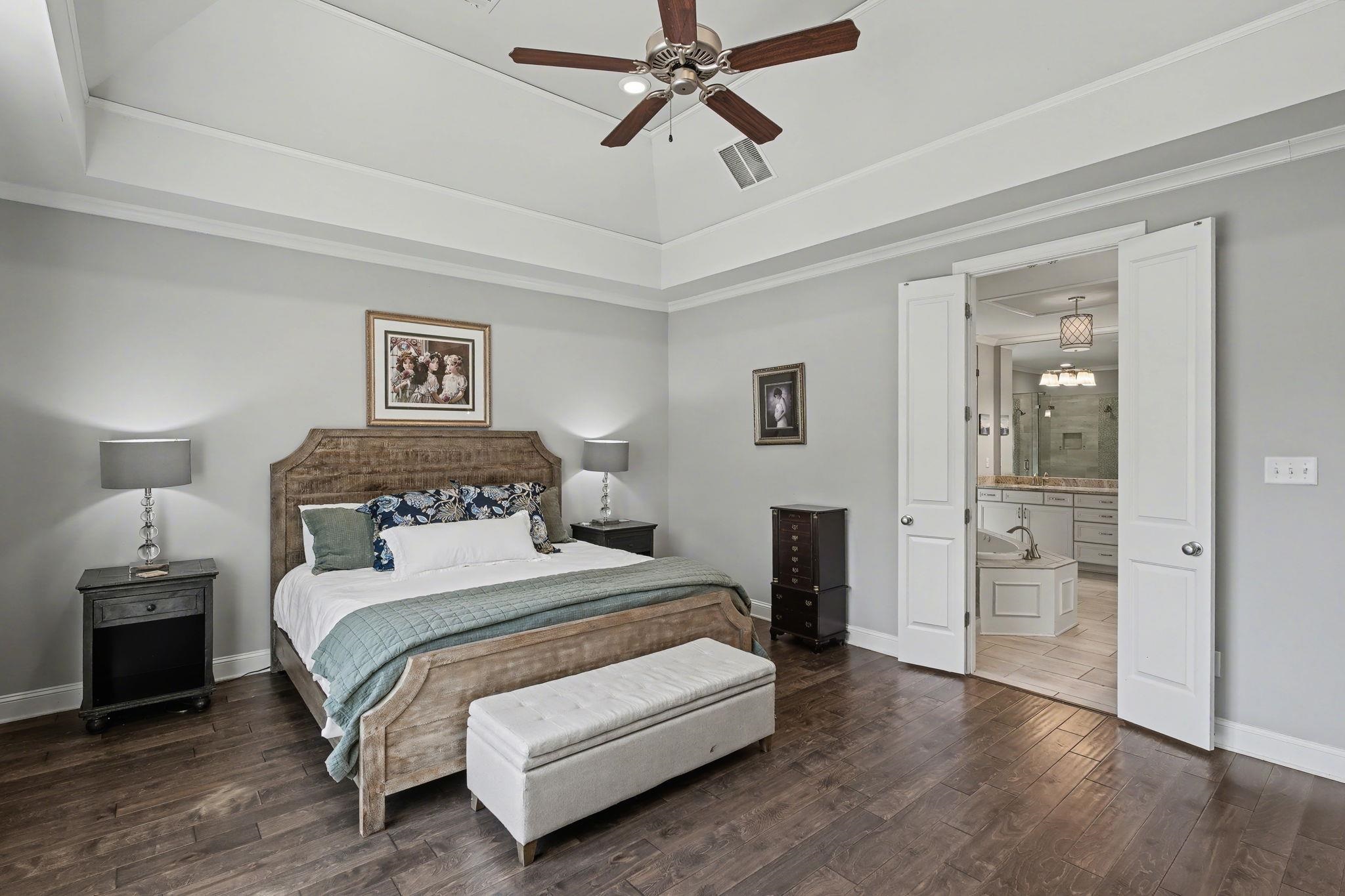 477 Fallen Timbers Cove Collierville, TN 38017 - Photo 17 of 40 a bedroom with a bed and a chandelier
