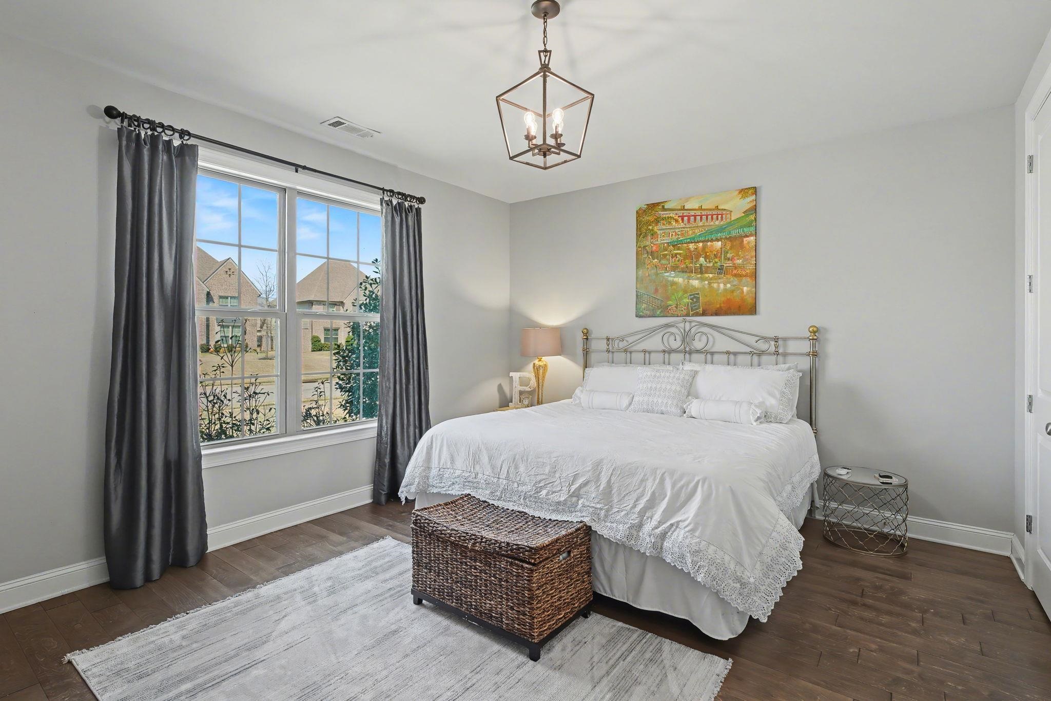 477 Fallen Timbers Cove Collierville, TN 38017 - Photo 24 of 40 a bedroom with a bed lamp and a large window