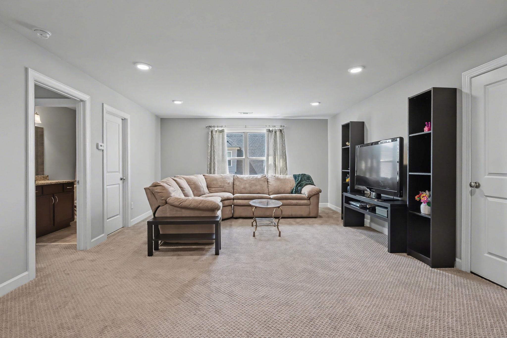 477 Fallen Timbers Cove Collierville, TN 38017 - Photo 27 of 40 a living room with furniture and a flat screen tv
