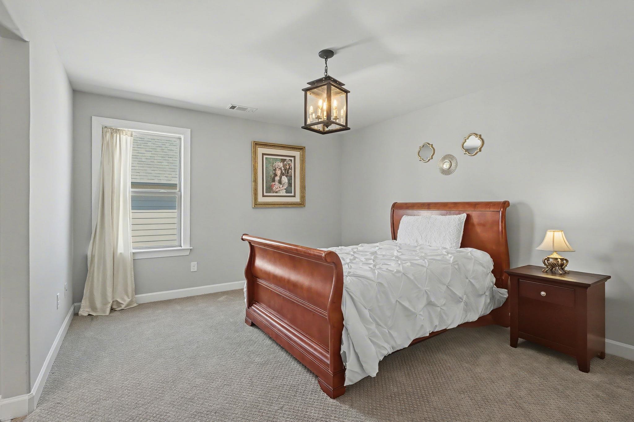 477 Fallen Timbers Cove Collierville, TN 38017 - Photo 30 of 40 a bedroom with a bed and window