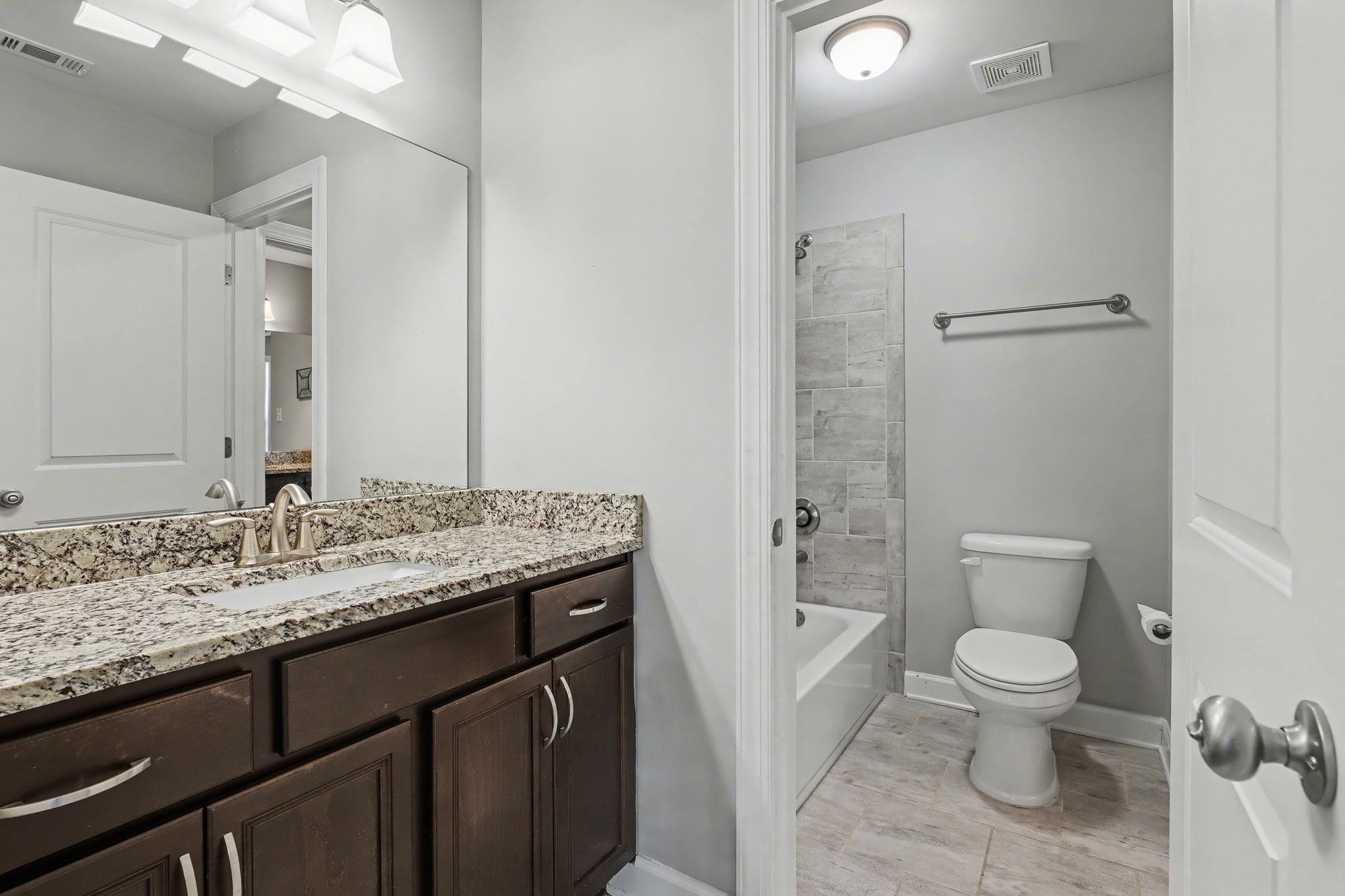 477 Fallen Timbers Cove Collierville, TN 38017 - Photo 31 of 40 a bathroom with a granite countertop sink toilet and shower