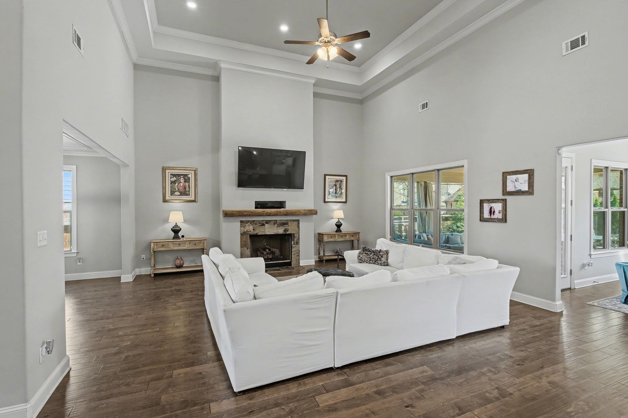 477 Fallen Timbers Cove Collierville, TN 38017 - Photo 7 of 40 a living room with furniture a fireplace and a flat screen tv