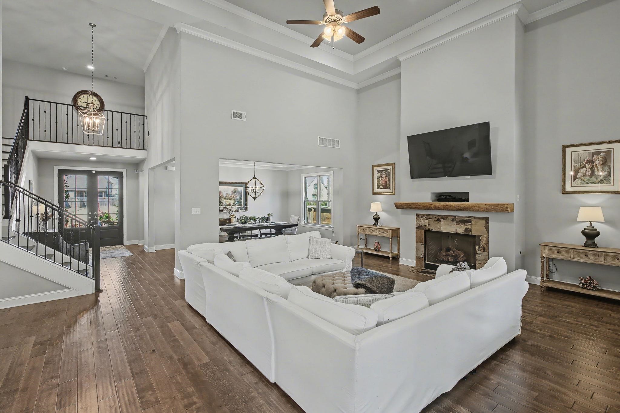 477 Fallen Timbers Cove Collierville, TN 38017 - Photo 8 of 40 a living room with furniture a fireplace and a flat screen tv