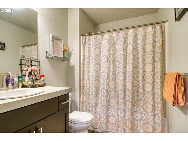 a bathroom with a sink toilet and a mirror