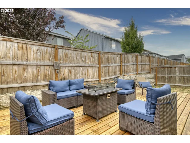 a view of a deck with couches table and chairs with wooden floor