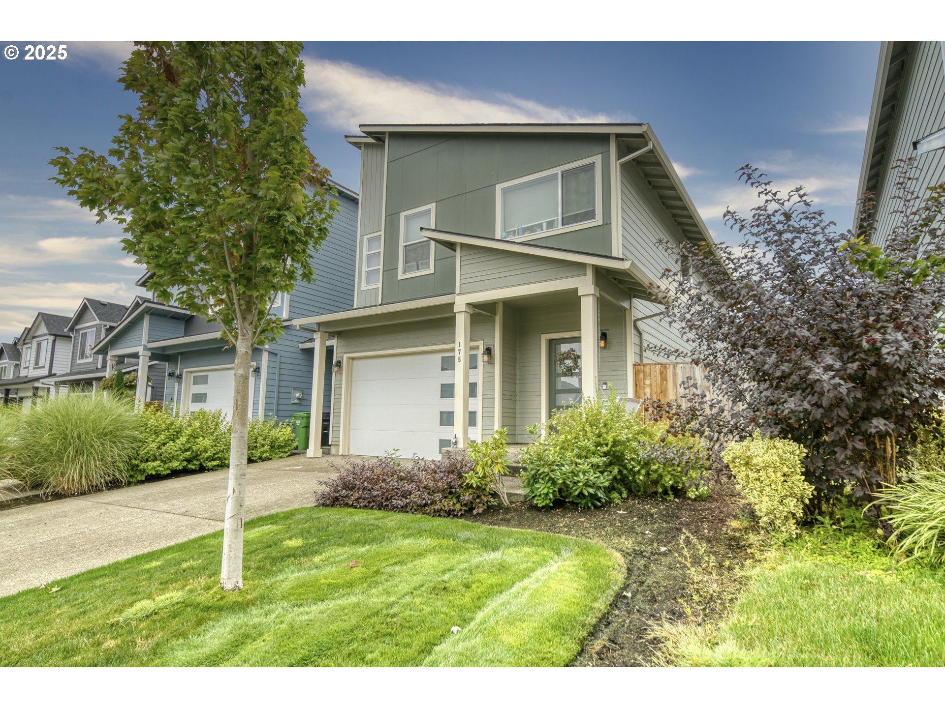 175 Kindre Street St. Helens, OR 97051 - Photo 2 of 22 a house that has a tree in front of the house