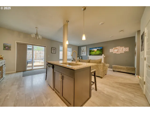a kitchen with a sink cabinets and wooden floor