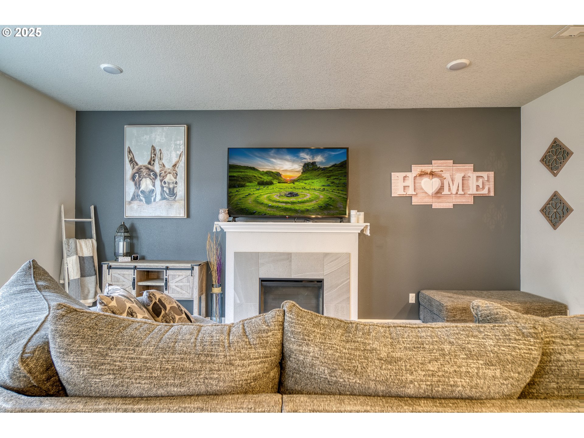 175 Kindre Street St. Helens, OR 97051 - Photo 7 of 22 a living room with furniture a fireplace and a flat screen tv